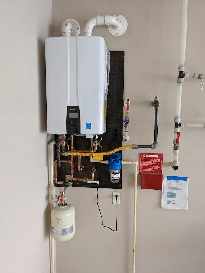 Professional plumber installing copper piping in a Essexville home